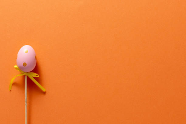 istock Decorative decoration in the form of Easter eggs on an orange background. Copy space. Easter holiday concept. 1217326654