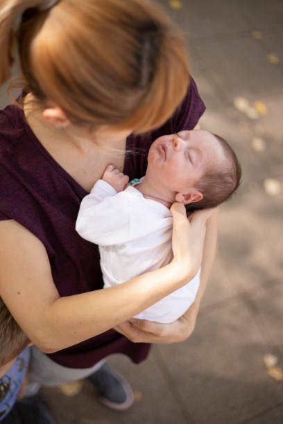 istock Feeling cozy in mom's arms 1217326888