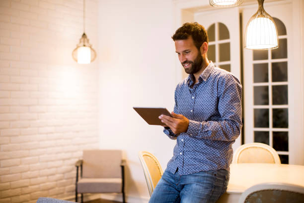 istock Young man working from home on digital tablet 1217327435