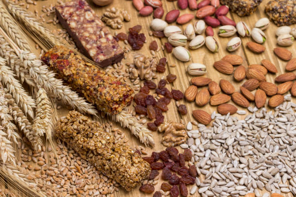 istock Cereal granola bars, sunflower seeds, nuts and wheat sprig 1217328090