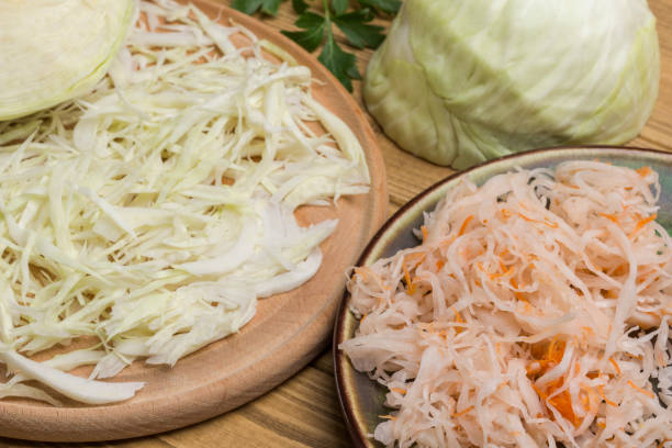 istock Sliced raw cabbage, Sauerkraut in plate, half cabbage head. 1217328120