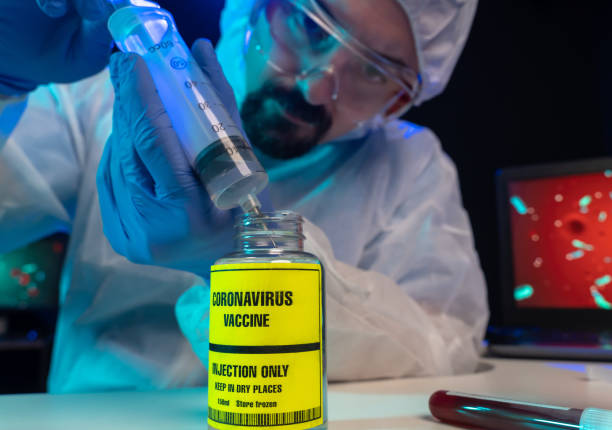 istock Lab scientist using  syringe and Coronavirus vaccine in laboratory, close-up 1217329228