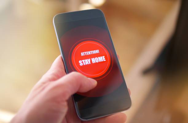 istock Emergency message Stay Home on the phone 1217329369