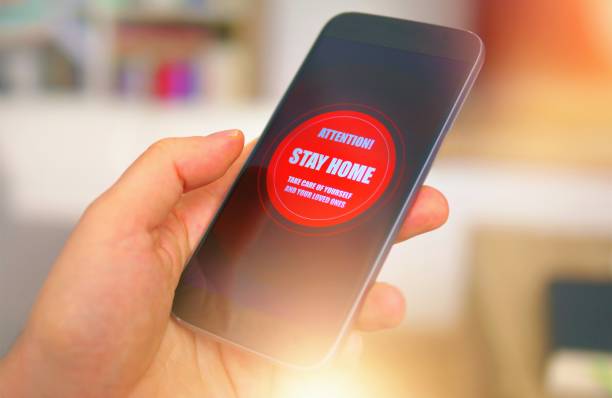 istock Emergency message Stay Home on the phone 1217329376