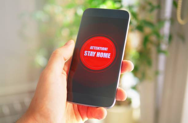 istock Emergency message Stay Home on the phone 1217329392