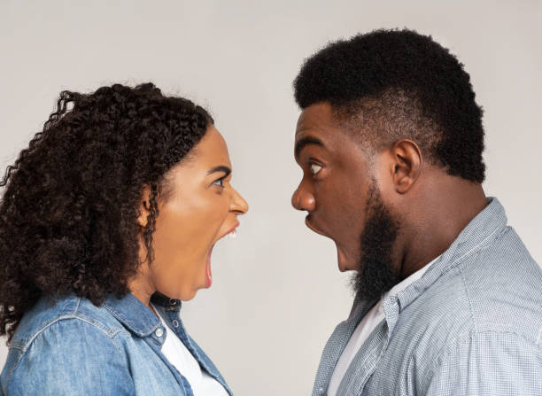 istock Relationship problems. Profile portrait of angry black couple arguing 1217329992