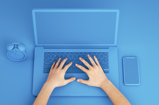 Empty Screen Smartphone and Laptop on Blue Background, Woman Touching Keyboard