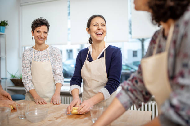 Group of people having fun at pasta workshop