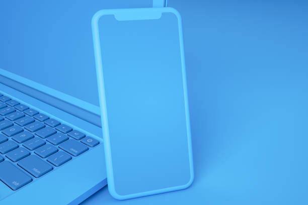 istock Empty Screen Smartphone and Laptop on Blue Background 1217332588