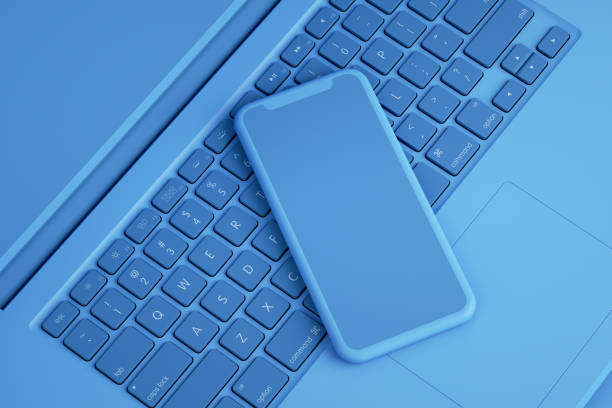 istock Smart Phone on Laptop, Minimal Technology Concept 1217332636