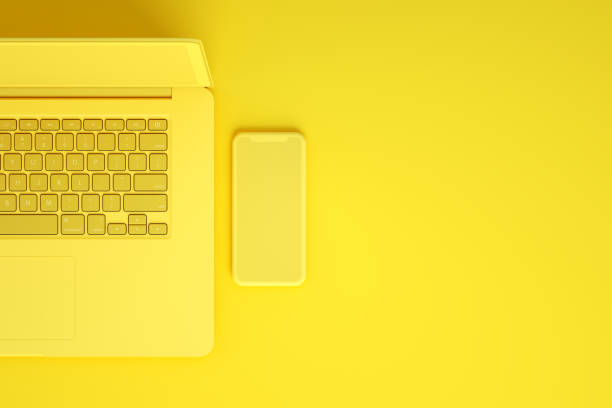 istock Empty Screen Smartphone and Laptop on Yellow Background 1217333067