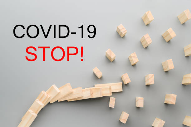 istock Stop coronavirus. Keep social distance to stop the domino effect. Preventive measures to combat the global spread of the pandemic. Horizontal orientation. 1217334302