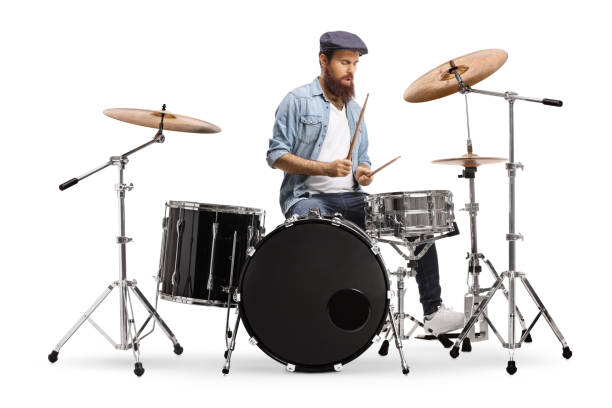 Casual bearded guy mucician playing a drum set Casual bearded guy mucician playing a drum set isolated on white background drummer stock pictures, royalty-free photos & images