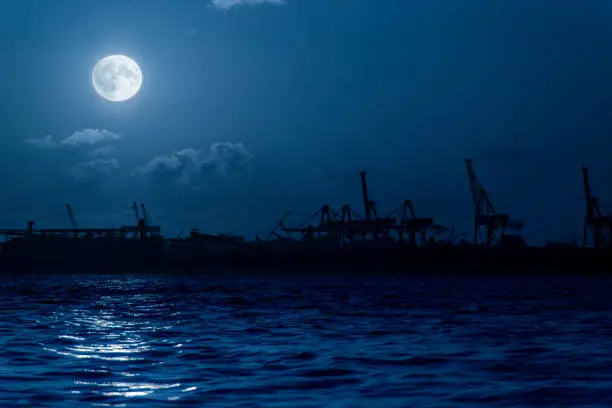 Sea Port Silhouette at Night with Moon in the Sky