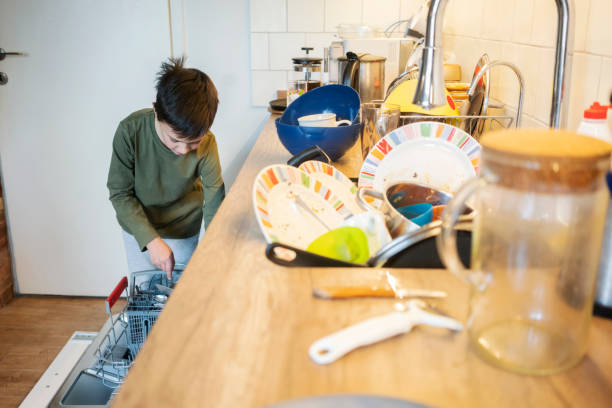 istock Boy busy taking care of a dishwashing machine 1217336904