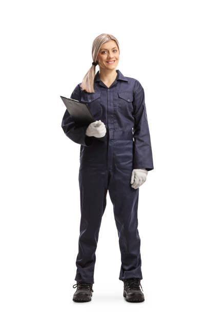 istock Female worker in an overall uniform standing with a clipboard 1217338179