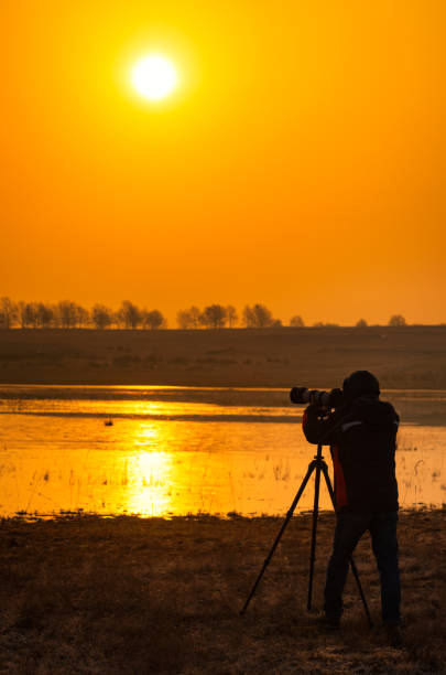 istock A photographer's silhouette at sunrise 1217338413