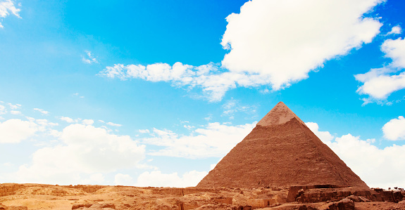 Ancient Egyptian Pyramid over Blue Sky