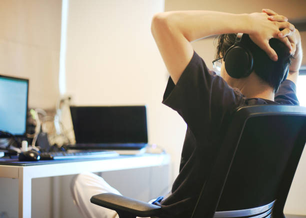 istock man resting his head on hands while listening music on a headphone 1217342451