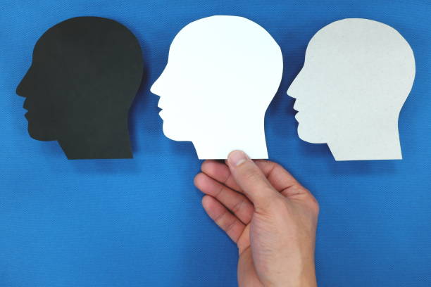 istock Hand choosing between multiple personality. Male head silhouette profile. 1217342509