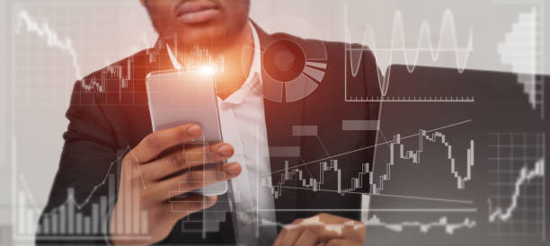 istock African American man working with mobile phone and laptop in office, collage with info on virtual interface. Panorama 1217345962