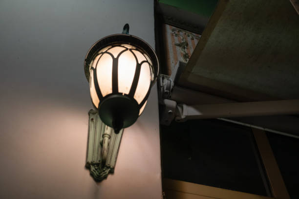 istock Classic wall lamp mounted on a wall on the street with copy space for text 1217346374