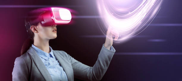 istock Businesswoman in virtual reality headset touching vitrual screen with data on dark background, collage 1217347354