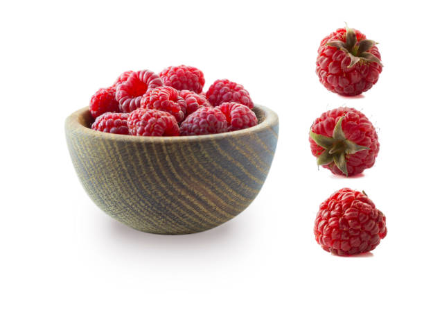 istock Raspberries isolated on white background. Raspberries on wooden bowl. Raspberry with copy space for text. Juicy and delicious raspberries isolation on white. Raspberries from different angles on white 1217348524