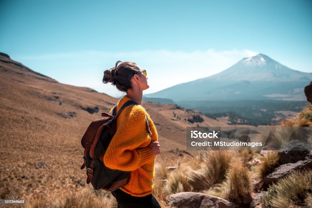Enjoying the view. Young Latin woman enjoying the view to Popocatepetl volcano Sunglasses Stock Photo