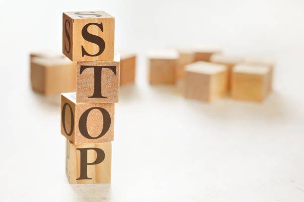 istock Four wooden cubes arranged in stack with word STOP on them, space for text image at down right corner 1217349949