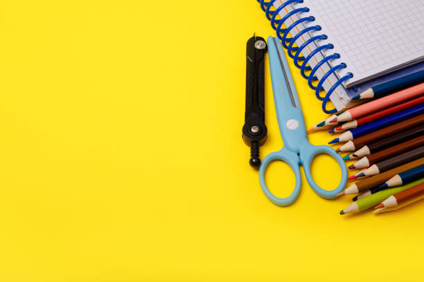 istock Colorful school supplies border over a lined paper background 1217350199