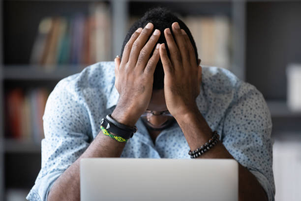 istock Stressed african American man frustrated by bad email 1217350980