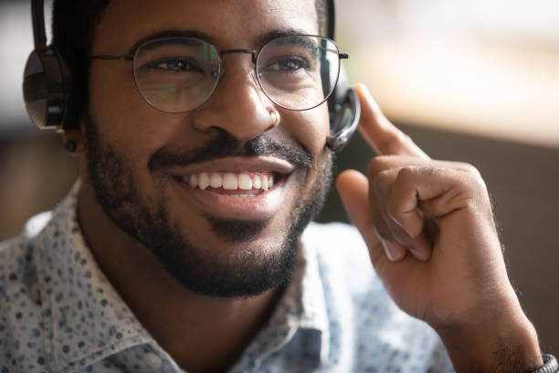 istock Happy biracial male telemarketer consult client online 1217351002