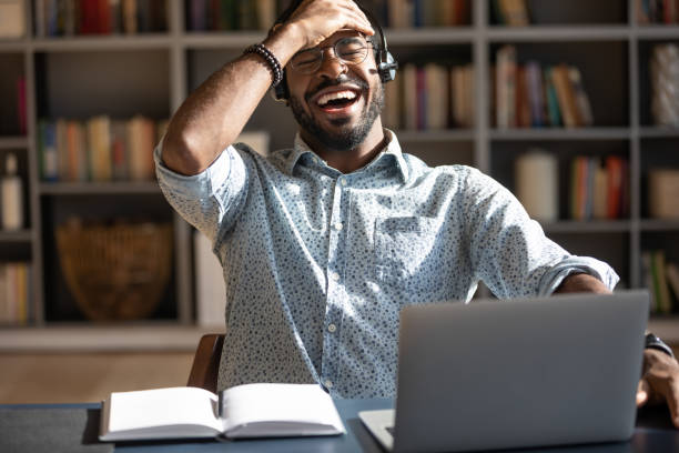 istock Smiling biracial man have fun watching webinar on laptop 1217351010