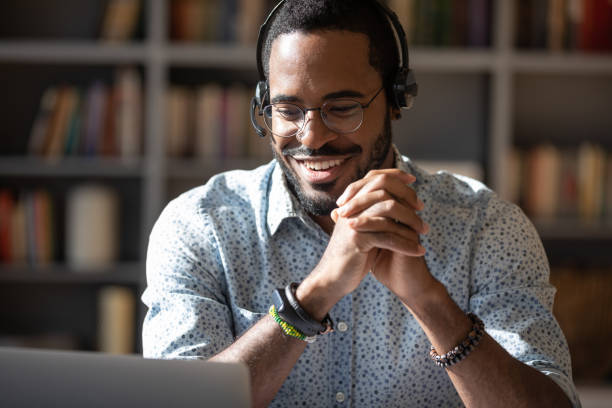 istock Smiling biracial male telemarketer consult client online 1217351023