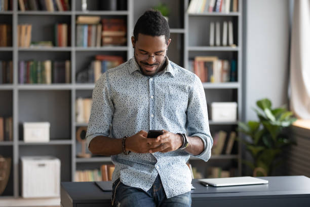 istock African American man busy texting on modern cellphone gadget 1217351031