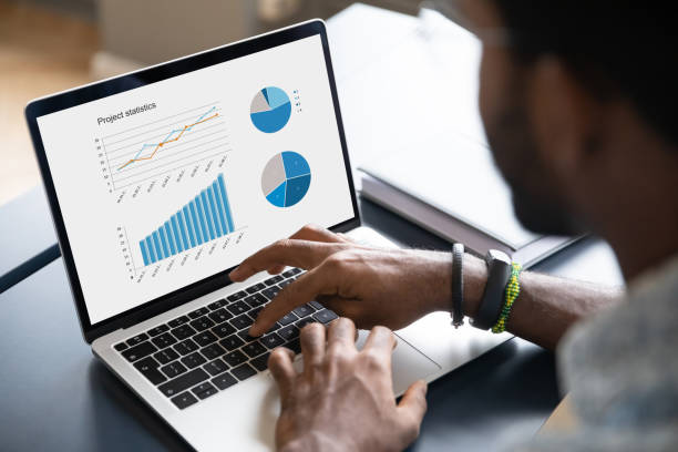 istock Close up of african American man analyzing stats on laptop 1217351038
