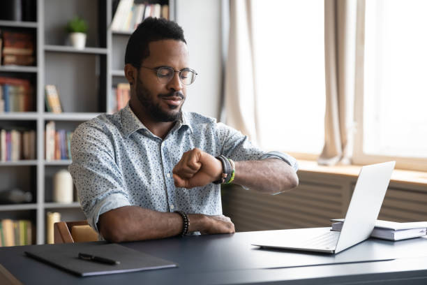 istock African American male employee check time at work 1217351056