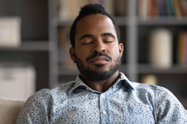 istock Exhausted biracial man fall asleep in living room 1217351081