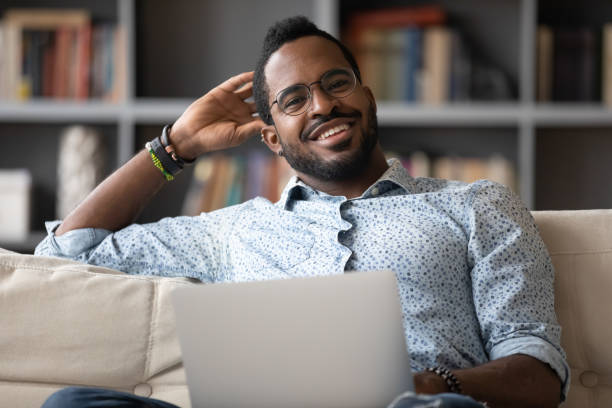istock Portrait of smiling biracial man using modern laptop 1217351094