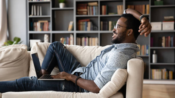 istock Smiling biracial man relax at home using laptop 1217351123