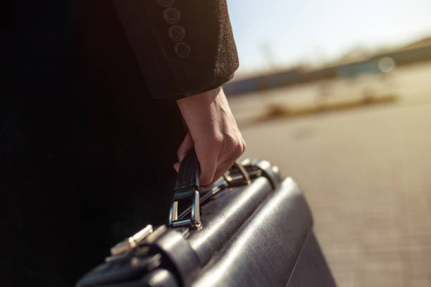 istock Businessman holding his briefcase in hand. 1217352940