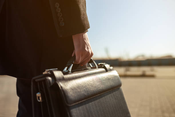 istock Businessman holding his briefcase in hand. 1217352944