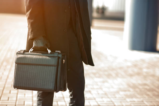 istock Businessman holding his briefcase in hand. 1217352963