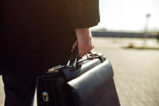 istock Businessman holding his briefcase in hand. 1217352964