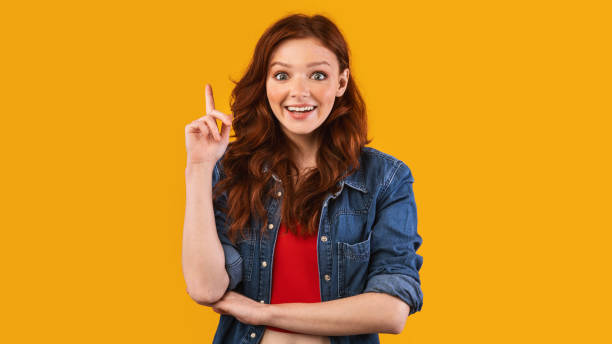 istock Girl Pointing Finger Up Having Idea Posing In Studio, Panorama 1217353442