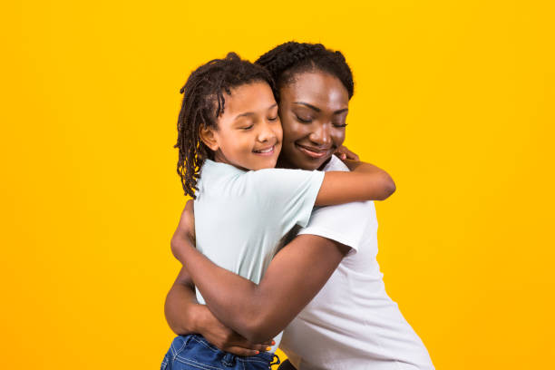 istock Black mother hugging with her happy girl 1217353495