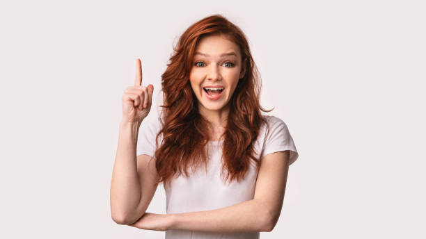 istock Excited Girl Pointing Finger Up Having Eureka Moment, Studio Shot 1217353549