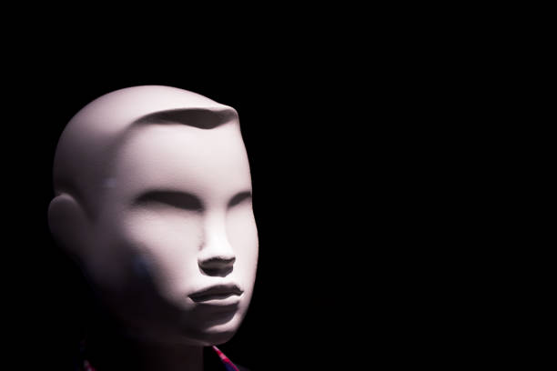 istock Child mannequin portrait on dark background without expression. No people 1217354911