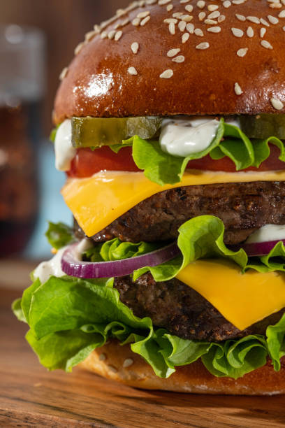 istock Big sandwich - hamburger burger with beef, tomato, cheese, pickled cucumber and red onion. 1217355231